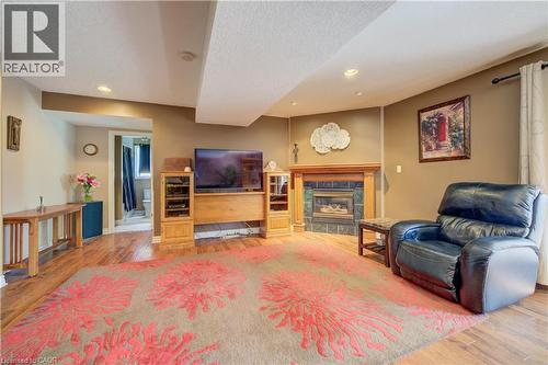 Spacious living area featuring wood-finish flooring and recessed lighting - 599 Coldstream Drive, Waterloo, ON - Indoor Photo Showing Other Room With Fireplace