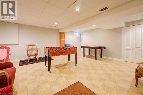 Spacious finished lower level featuring light-toned tile flooring, recessed lighting, and neutral wall paint - 599 Coldstream Drive, Waterloo, ON - Indoor Photo Showing Other Room