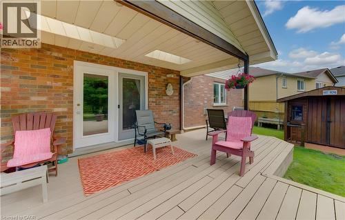 Covered patio deck featuring a brick exterior wall and dual skylights - 599 Coldstream Drive, Waterloo, ON - Outdoor With Deck Patio Veranda With Exterior