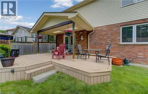 Multi-level composite deck with integrated steps, featuring a covered patio area with a skylight - 599 Coldstream Drive, Waterloo, ON - Outdoor With Deck Patio Veranda
