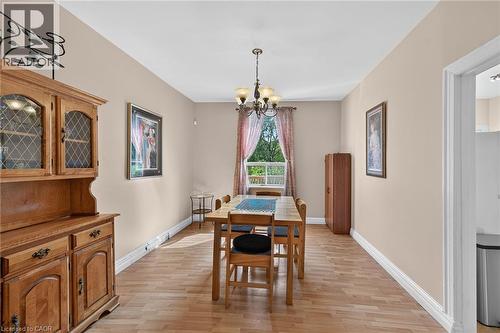 Wood-finish flooring, neutral wall tones, and a window with natural light - 230 Picton Street E, Hamilton, ON - Indoor Photo Showing Dining Room