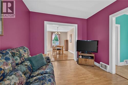 Wood-finish flooring throughout, with a wide cased opening leading to an additional space - 230 Picton Street E, Hamilton, ON - Indoor Photo Showing Living Room
