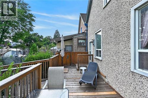 Raised wooden deck with a privacy fence and exterior wall with multiple windows - 230 Picton Street E, Hamilton, ON - Outdoor With Deck Patio Veranda With Exterior