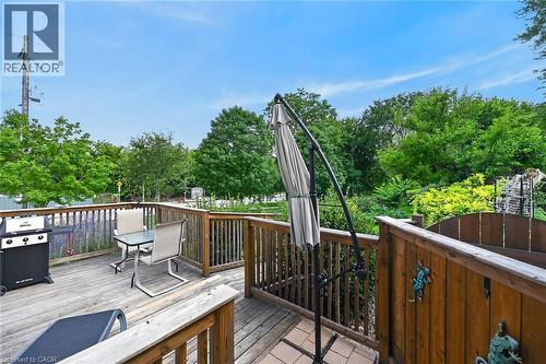 Wood deck with wood railings, surrounded by mature trees and landscaping - 230 Picton Street E, Hamilton, ON - Outdoor With Deck Patio Veranda