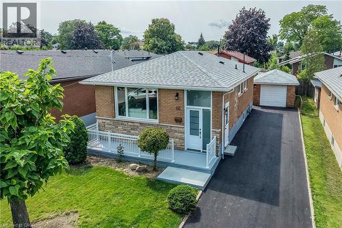 Brick and stone exterior with a gray shingle roof - 40 Purdy Crescent, Hamilton, ON - Outdoor