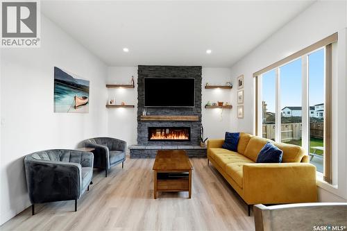 302 Chelsom Manor, Saskatoon, SK - Indoor Photo Showing Living Room With Fireplace