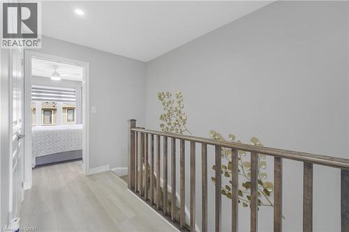 Wood-finish flooring throughout the hallway - 1890 Rymal Road E Unit# 144, Hamilton, ON - Indoor Photo Showing Other Room