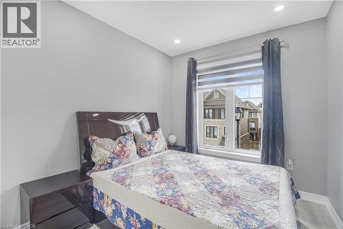 Recessed lighting, wood-finish flooring, and a large window with roller shades - 1890 Rymal Road E Unit# 144, Hamilton, ON - Indoor Photo Showing Bedroom