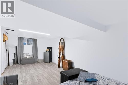 Recessed window with natural light, wood-finish flooring, and white walls - 703 Brighton Avenue, Hamilton, ON - Indoor