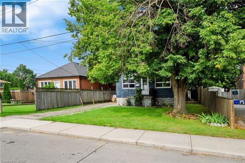 Deep blue siding exterior with white window trim - 703 Brighton Avenue, Hamilton, ON - Outdoor