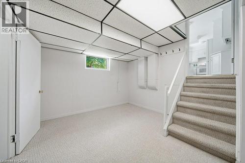 Recessed lighting, drop ceiling, wall-to-wall carpeting, window, white painted walls - 64 Warren Road, Kitchener, ON - Indoor Photo Showing Other Room