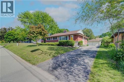Red brick exterior with white trim, a gabled roof, and an attached two-car garage - 251 Union Street E, Waterloo, ON - Outdoor