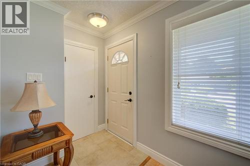 Light-toned tile flooring, light gray walls, white door with arched transom, and a large window with blinds - 251 Union Street E, Waterloo, ON - Indoor Photo Showing Other Room