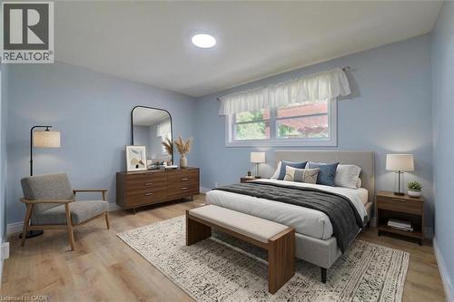 Recessed ceiling light, wood-finish flooring, light blue wall paint, white window trim, and a window with natural light - 251 Union Street E, Waterloo, ON - Indoor Photo Showing Bedroom