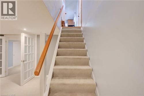 Carpeted staircase with a wood handrail, recessed lighting, and French doors - 251 Union Street E, Waterloo, ON - Indoor Photo Showing Other Room