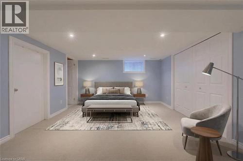 Recessed lighting throughout, light blue wall paint, white trim, window, and bi-fold closet doors - 251 Union Street E, Waterloo, ON - Indoor Photo Showing Bedroom