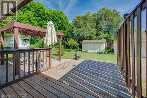 Wood-finish deck with railing, pergola, and gravel patio area - 251 Union Street E, Waterloo, ON - Outdoor With Exterior