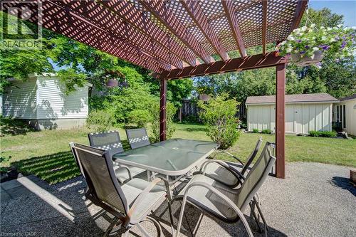 Expansive patio featuring a wooden pergola, concrete surfacing, and a visible storage shed - 251 Union Street E, Waterloo, ON - Outdoor