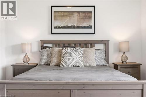 Gray-toned wood bed frame with slatted headboard - 4171 Palermo Common, Burlington, ON - Indoor Photo Showing Bedroom