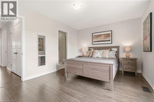 Primary Bedroom with wood-finish flooring, neutral wall finishes, and abundant natural light - 4171 Palermo Common, Burlington, ON - Indoor Photo Showing Bedroom