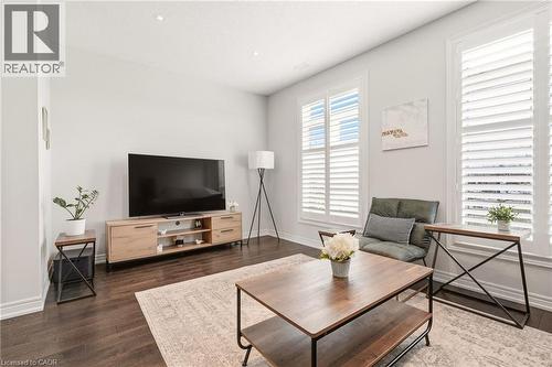 Recessed lighting illuminates wood-finish flooring and white walls - 4171 Palermo Common, Burlington, ON - Indoor Photo Showing Living Room