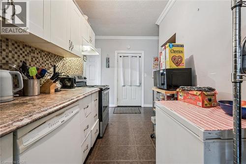Full kitchen featuring white cabinetry, a mosaic tile backsplash, and a built-in dishwasher - 27 Roseview Avenue, Cambridge, ON - Indoor Photo Showing Kitchen