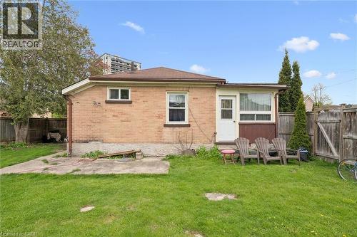 Brick ranch home with a spacious rear lawn featuring mature landscaping and established trees - 27 Roseview Avenue, Cambridge, ON - Outdoor