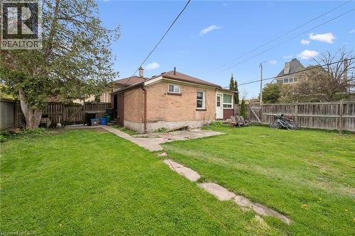 Spacious brick residence with a generous backyard featuring mature landscaping, manicured lawn, and wooden privacy fencing - 27 Roseview Avenue, Cambridge, ON - Outdoor