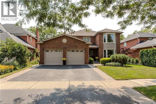 Brick exterior with a prominent two-car garage - 1238 Sable Drive, Burlington, ON - Outdoor With Facade