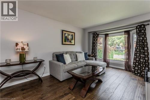 Wood-finish flooring throughout, featuring a bay window, and light-toned wall paint - 1238 Sable Drive, Burlington, ON - Indoor Photo Showing Living Room