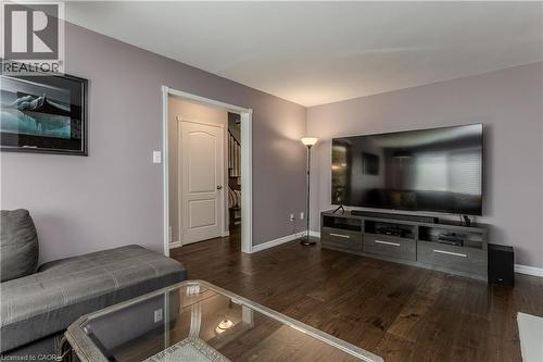 Dark wood-finish flooring complemented by light purple walls - 1238 Sable Drive, Burlington, ON - Indoor Photo Showing Living Room
