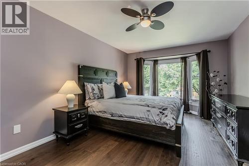 Bay window, wood-finish flooring, ceiling fan, and built-in headboard - 1238 Sable Drive, Burlington, ON - Indoor Photo Showing Bedroom