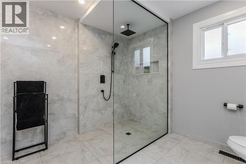 Glass-enclosed shower with black-framed detailing, recessed lighting, and a built-in shower niche - 1238 Sable Drive, Burlington, ON - Indoor Photo Showing Bathroom