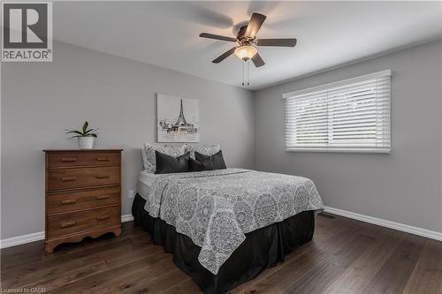 Wood-finish flooring, ceiling fan with integrated lighting, window with horizontal blinds, and neutral wall tones - 1238 Sable Drive, Burlington, ON - Indoor Photo Showing Bedroom