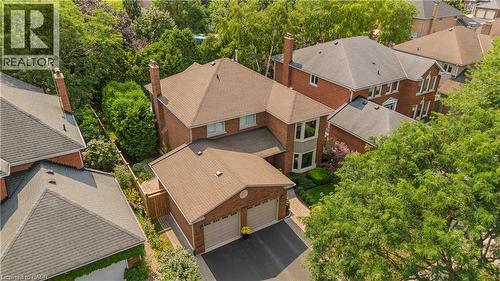 Brick exterior with multiple chimneys, bay window, and attached two-car garage - 1238 Sable Drive, Burlington, ON - Outdoor
