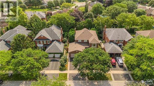 Brick exterior residence with a shingled roof, mature trees, and a paved driveway - 1238 Sable Drive, Burlington, ON - Outdoor