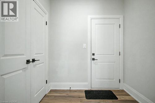 Wood-finish flooring with white trim - 31 Fourth Avenue, Kitchener, ON - Indoor Photo Showing Other Room