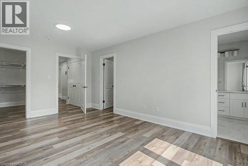 Wood-finish flooring, recessed ceiling lighting, light gray wall paint, and white trim - 31 Fourth Avenue, Kitchener, ON - Indoor Photo Showing Other Room