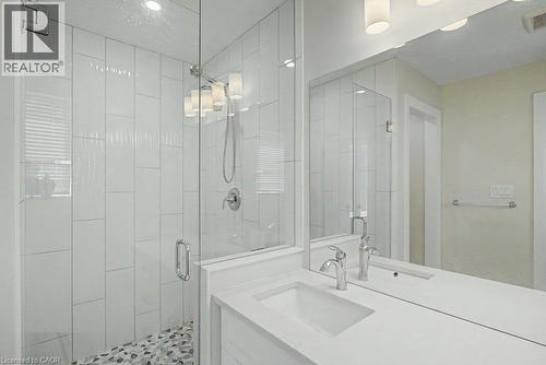 Glass-enclosed shower with subway tile surround and pebble flooring - 31 Fourth Avenue, Kitchener, ON - Indoor Photo Showing Bathroom