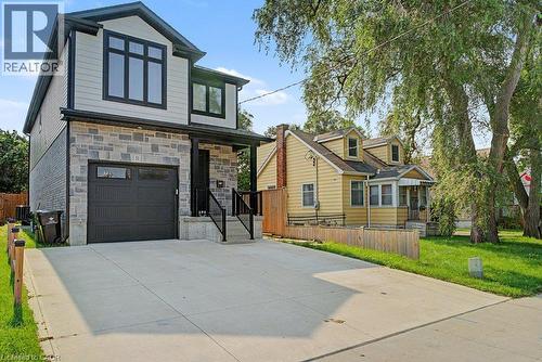 Two-story residence featuring light gray siding and stone veneer - 31 Fourth Avenue, Kitchener, ON - Outdoor