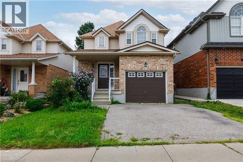 Two-story residence featuring a brick facade, dormer windows, and a covered porch - 248 Bridlewreath Street, Kitchener, ON - Outdoor With Facade