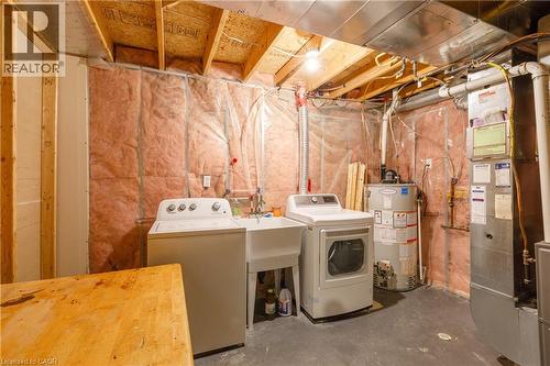 Laundry area featuring washer, dryer, utility sink, water heater, and furnace - 248 Bridlewreath Street, Kitchener, ON - Indoor Photo Showing Laundry Room
