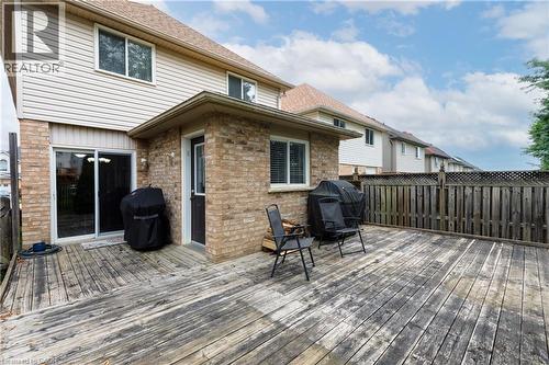 Expansive rear wooden deck, brick exterior, sliding glass door access, and privacy fencing - 248 Bridlewreath Street, Kitchener, ON - Outdoor With Deck Patio Veranda With Exterior