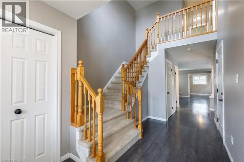 Split-level staircase with wood-finish balusters, carpeting, and wood-finish flooring - 248 Bridlewreath Street, Kitchener, ON - Indoor Photo Showing Other Room