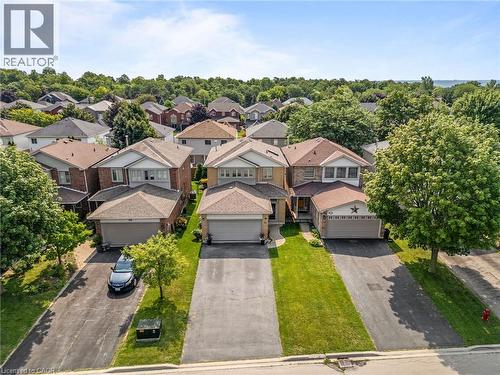 Two-story residence featuring a two-car garage, front yard landscaping, and an asphalt driveway - 57 Grindstone Way, Waterdown, ON - Outdoor With Facade