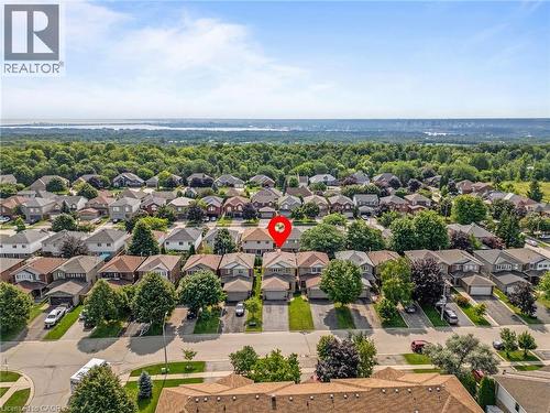 Residential neighborhood setting with mature trees and visible distant water - 57 Grindstone Way, Waterdown, ON - Outdoor With View