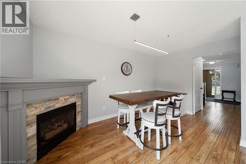 Fireplace with stone surround and wood mantel - 57 Grindstone Way, Waterdown, ON - Indoor Photo Showing Other Room With Fireplace