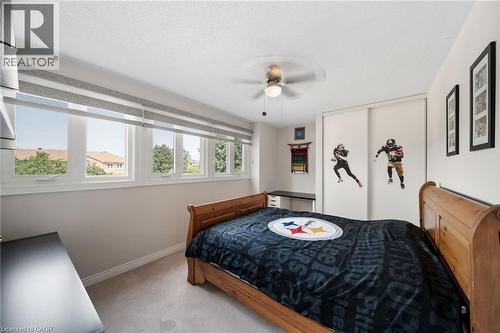 Room with multiple windows featuring blinds, a ceiling fan, and sliding closet doors - 57 Grindstone Way, Waterdown, ON - Indoor Photo Showing Bedroom