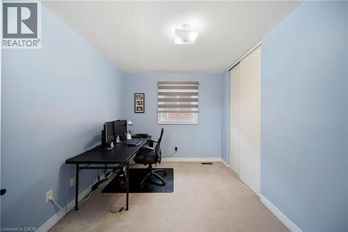 Light blue painted walls, neutral carpet flooring, and a window with horizontal blinds - 57 Grindstone Way, Waterdown, ON - Indoor Photo Showing Office
