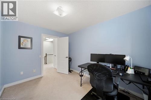 Carpeted flooring, light blue wall finishes, white trim, and a white interior door - 57 Grindstone Way, Waterdown, ON - Indoor Photo Showing Office